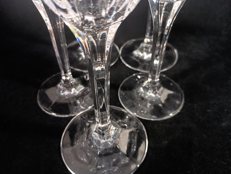 Vintage Mikasa Uptown clear heavy cut crytal stemware. This 5 piece set consists of three 9 inch water goblets and two 9 1/2 inch fluted champagne glasses. The bowls are vertically cut and polished from the rim to the stem and one horizontal spiral around the bowl. The tall slender stems are six-sided and curver gracerully into thesix-segmented foot.