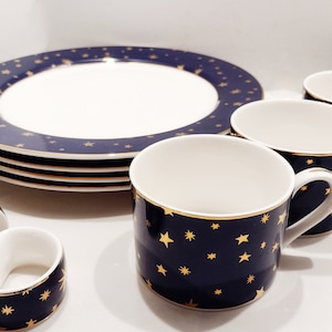 Vintage Sakura Galaxy Dinnerware set. 4 dinner plates, 4 flat cups and 4 napkin rings in original box