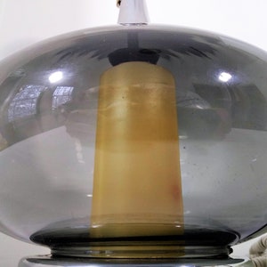 Mid Century Modern Minimalist Blenko Art Glass Table Lamp. Hand blown smoke glass garlic shape body, chrome finish neck and base. Fiberglass light diffuser inside glass body for mood light.