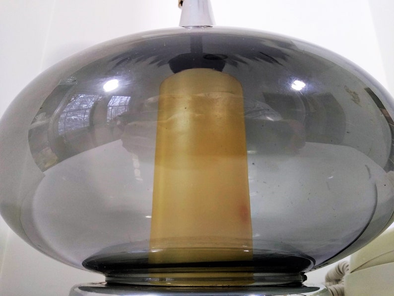 Mid Century Modern Minimalist Blenko Art Glass Table Lamp. Hand blown smoke glass garlic shape body, chrome finish neck and base. Fiberglass light diffuser inside glass body for mood light.