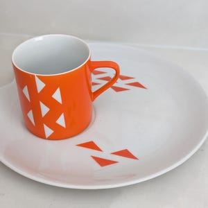Jonas Roberts Japan snack set with white yin yang snack plate with orange diamonds and orange cup with white diamond pattern