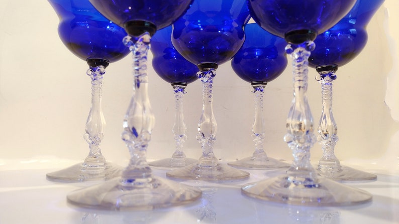 Set of 7 Antique Cobalt Royal Blue 3126 Cambridge Glass Champagne / Tall Sherbet Stemware.  Beautiful, clear cobalt blue art deco style angular flare top on a bulbous, bulging bowl with graceful foliated clear glass tall stems.