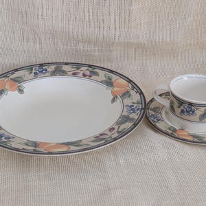 Mikasa Garden Harvest CAC29 stoneware pasta bowl, cup and saucer set with fruit and leaf border on cream glaze.