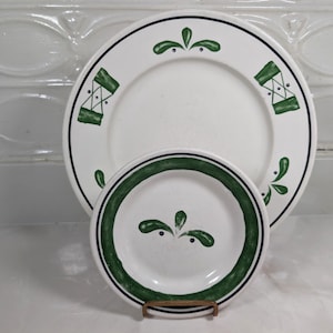 May include: A white ceramic mug with a black handle and the text "But First, Coffee" in a black, bold font. The mug is sitting on a white surface.