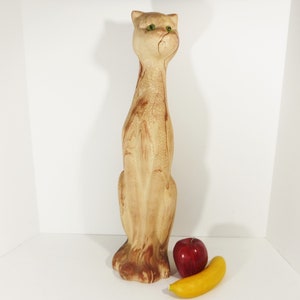 Tall and Lean Mountain Lion Cat Souvenir from Glacier Park. 1970s Nemadji like clay body looks like flowing rivers of light to dark brown sand. Pottery Mid Century Style wild cougar with glass or plastic green eyes. 22 inches tall,