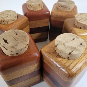 Mid Century Turned Stacked Layered Wood Spice Containers with Cork Stoppers. Set of 6 wooden spice jars  ade of Layers of various varieties of dark and light colored wood stacked together, turned, and finished to warm rich layers of natural wood.