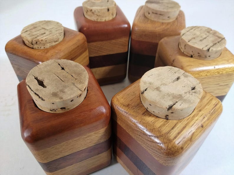 Mid Century Turned Stacked Layered Wood Spice Containers with Cork Stoppers. Set of 6 wooden spice jars  ade of Layers of various varieties of dark and light colored wood stacked together, turned, and finished to warm rich layers of natural wood.