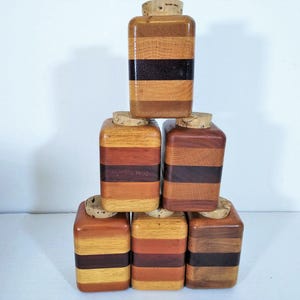 Mid Century Turned Stacked Layered Wood Spice Containers with Cork Stoppers. Set of 6 wooden spice jars  ade of Layers of various varieties of dark and light colored wood stacked together, turned, and finished to warm rich layers of natural wood.