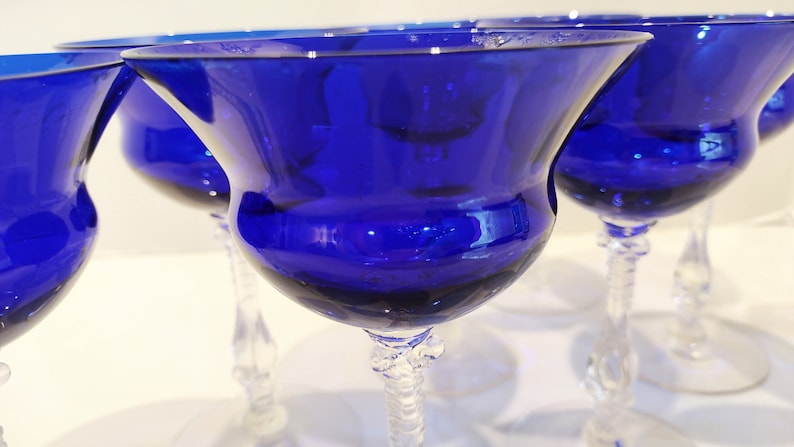 Set of 7 Antique Cobalt Royal Blue 3126 Cambridge Glass Champagne / Tall Sherbet Stemware.  Beautiful, clear cobalt blue art deco style angular flare top on a bulbous, bulging bowl with graceful foliated clear glass tall stems.