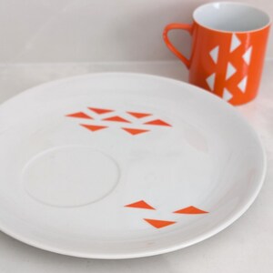 Jonas Roberts Japan snack set with white yin yang snack plate with orange diamonds and orange cup with white diamond pattern