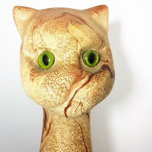 Tall and Lean Mountain Lion Cat Souvenir from Glacier Park. 1970s Nemadji like clay body looks like flowing rivers of light to dark brown sand. Pottery Mid Century Style wild cougar with glass or plastic green eyes. 22 inches tall,