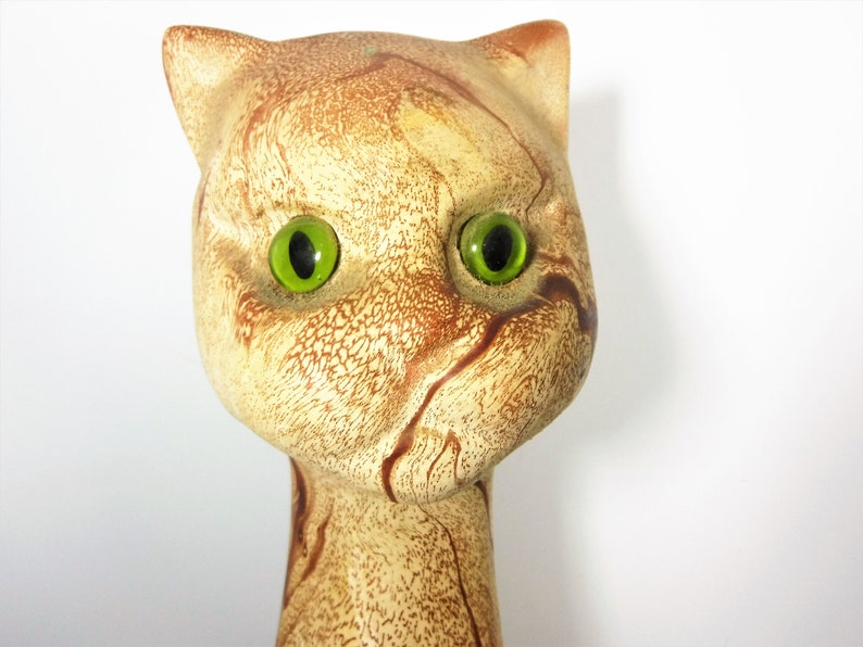 Tall and Lean Mountain Lion Cat Souvenir from Glacier Park. 1970s Nemadji like clay body looks like flowing rivers of light to dark brown sand. Pottery Mid Century Style wild cougar with glass or plastic green eyes. 22 inches tall,