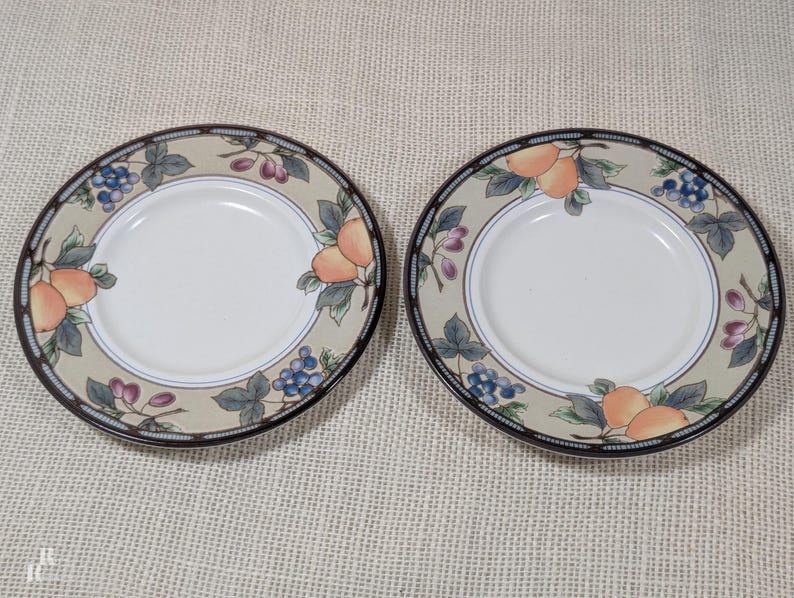 Mikasa Garden Harvest CAC29 set of 2 saucers with fruit and leaf border on cream glaze.