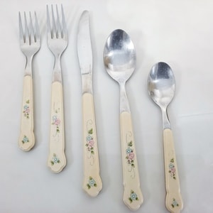 May include: Set of five silver-toned flatware with floral patterned handles. The set includes two forks, a knife, and two spoons.