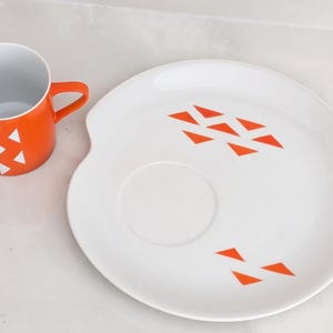 Jonas Roberts Japan snack set with white yin yang snack plate with orange diamonds and orange cup with white diamond pattern