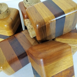 Mid Century Turned Stacked Layered Wood Spice Containers with Cork Stoppers. Set of 6 wooden spice jars  ade of Layers of various varieties of dark and light colored wood stacked together, turned, and finished to warm rich layers of natural wood.