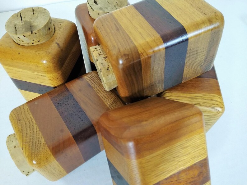 Mid Century Turned Stacked Layered Wood Spice Containers with Cork Stoppers. Set of 6 wooden spice jars  ade of Layers of various varieties of dark and light colored wood stacked together, turned, and finished to warm rich layers of natural wood.
