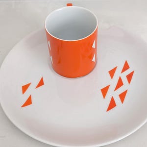 Jonas Roberts Japan snack set with white yin yang snack plate with orange diamonds and orange cup with white diamond pattern