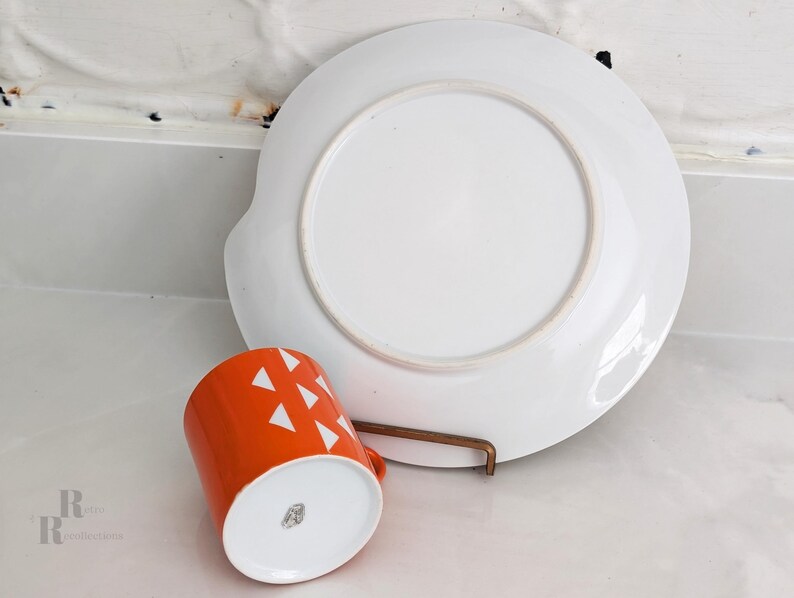 Jonas Roberts Japan snack set with white yin yang snack plate with orange diamonds and orange cup with white diamond pattern