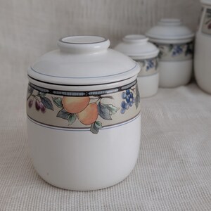 Mikasa Garden Harvest CAC29 stoneware Medium canister with fruit and leaf border on cream glaze.
