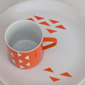Jonas Roberts Japan snack set with white yin yang snack plate with orange diamonds and orange cup with white diamond pattern