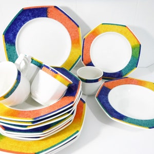 May include: A set of colorful octagonal ceramic dinnerware with a blue, green, yellow, and orange design. The set includes a large bowl, a plate, and two cups.