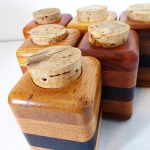 Mid Century Turned Stacked Layered Wood Spice Containers with Cork Stoppers. Set of 6 wooden spice jars  ade of Layers of various varieties of dark and light colored wood stacked together, turned, and finished to warm rich layers of natural wood.
