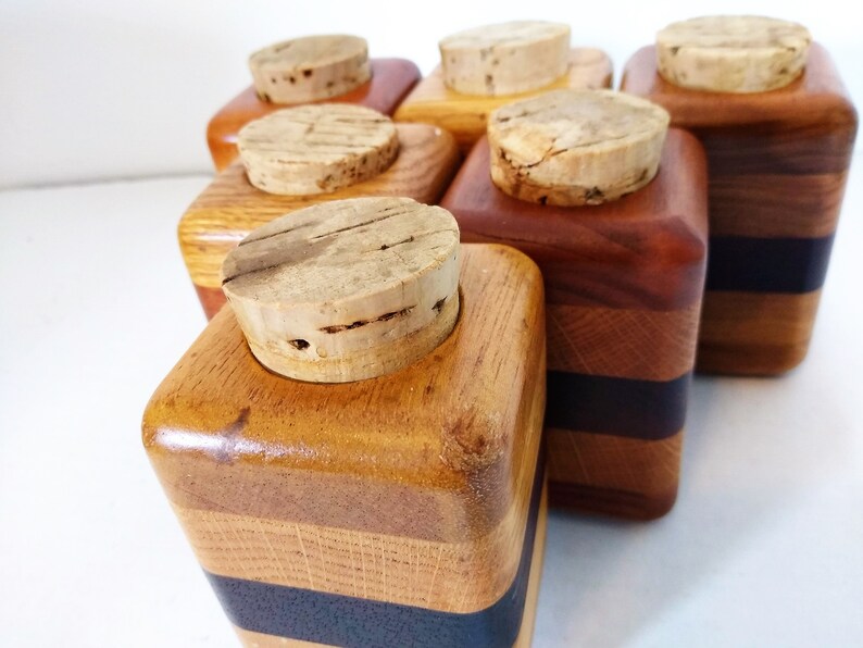 Mid Century Turned Stacked Layered Wood Spice Containers with Cork Stoppers. Set of 6 wooden spice jars  ade of Layers of various varieties of dark and light colored wood stacked together, turned, and finished to warm rich layers of natural wood.