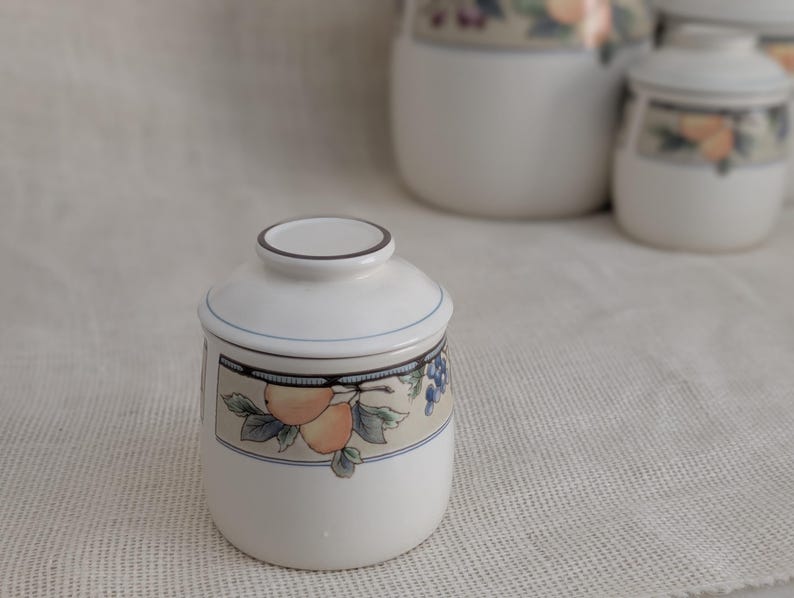 Mikasa Garden Harvest CAC29 stoneware Mini canister with fruit and leaf border on cream glaze.