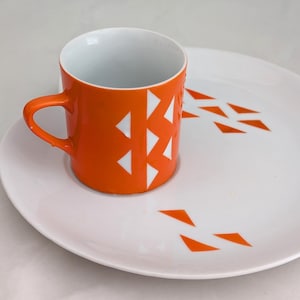 Jonas Roberts Japan snack set with white yin yang snack plate with orange diamonds and orange cup with white diamond pattern