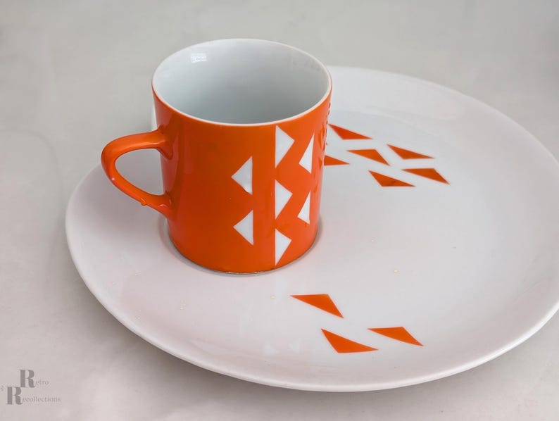 Jonas Roberts Japan snack set with white yin yang snack plate with orange diamonds and orange cup with white diamond pattern