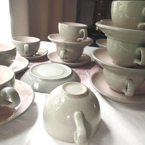 Harkerware Oven Proof Shell pink dinnerware pieces. Shell pink with dove gray undersides. Mid Century Modern plates, cups and saucers sold in set