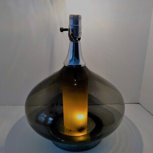Mid Century Modern Minimalist Blenko Art Glass Table Lamp. Hand blown smoke glass garlic shape body, chrome finish neck and base. Fiberglass light diffuser inside glass body for mood light.