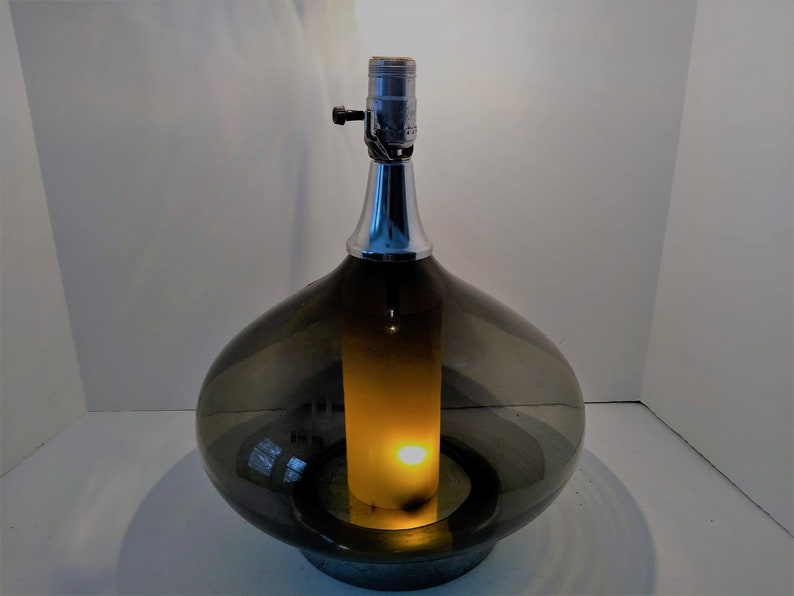 Mid Century Modern Minimalist Blenko Art Glass Table Lamp. Hand blown smoke glass garlic shape body, chrome finish neck and base. Fiberglass light diffuser inside glass body for mood light.