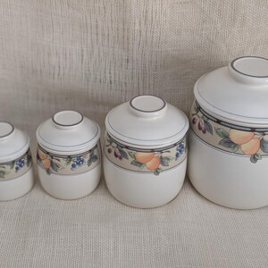 Mikasa Garden Harvest CAC29 stoneware canister set with fruit and leaf border on cream glaze.