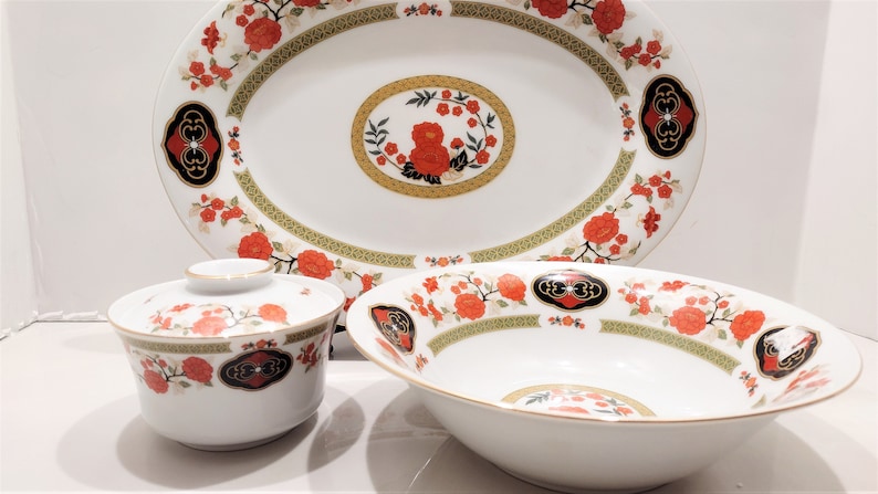 Lilily Cakara Dinnerware set, service for 8 Dinner plartes, salad plates, Soup Bowl, cup and saucer. Also Large oval platter, vegetable bowl and Covered Sugar (1)