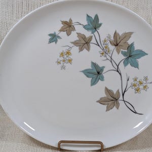 Mid‑century Syracuse China Woodbine pieces including an oval platter with the aqua and brown floral motif on a bright white glaze.