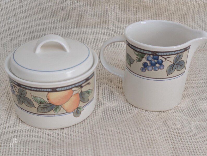 Mikasa Garden Harvest CAC29 stoneware Covered Sugar and Creamer with fruit and leaf border on cream glaze.