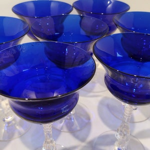Set of 7 Antique Cobalt Royal Blue 3126 Cambridge Glass Champagne / Tall Sherbet Stemware.  Beautiful, clear cobalt blue art deco style angular flare top on a bulbous, bulging bowl with graceful foliated clear glass tall stems.