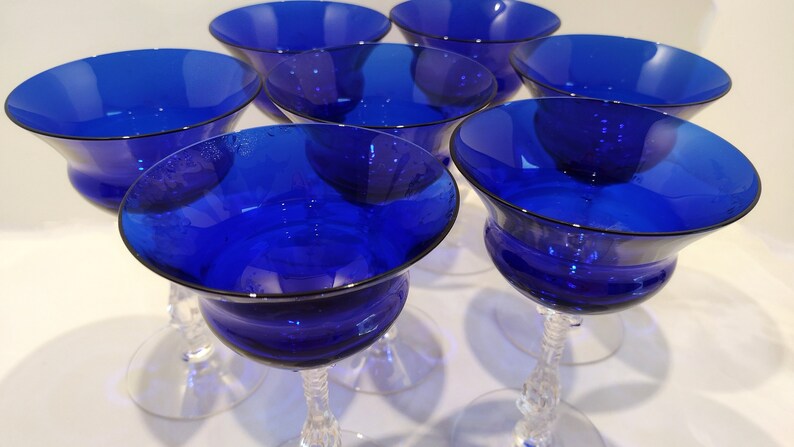 Set of 7 Antique Cobalt Royal Blue 3126 Cambridge Glass Champagne / Tall Sherbet Stemware.  Beautiful, clear cobalt blue art deco style angular flare top on a bulbous, bulging bowl with graceful foliated clear glass tall stems.