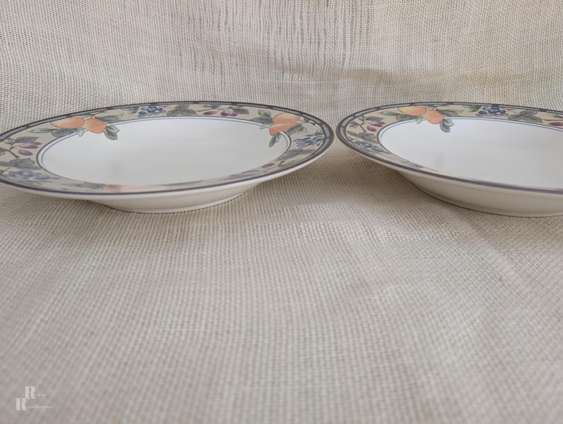 Set of 2 Garden Harvest pasta bowls with wide rim and deep center well.with fruit and leaf border on cream glaze.