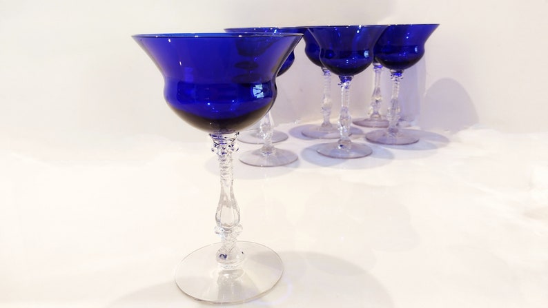 Set of 7 Antique Cobalt Royal Blue 3126 Cambridge Glass Champagne / Tall Sherbet Stemware.  Beautiful, clear cobalt blue art deco style angular flare top on a bulbous, bulging bowl with graceful foliated clear glass tall stems.