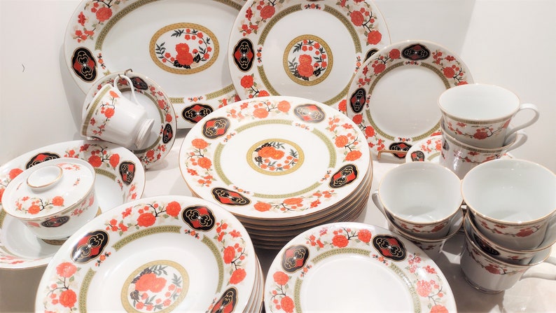 Lilily Cakara Dinnerware set, service for 8 Dinner plartes, salad plates, Soup Bowl, cup and saucer. Also Large oval platter, vegetable bowl and Covered Sugar (1)