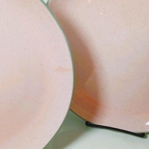 May include: Two Shell pink Vintage Harkerware shell pink dinner plates with   speckled Matte glaze and dove gray undersides.