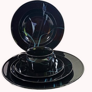 Mikasa Galleria Opus Black five piece place setting. Mystical Calla Lilys on black dinner plate, salad plate, soup bowl, cup and saucers.