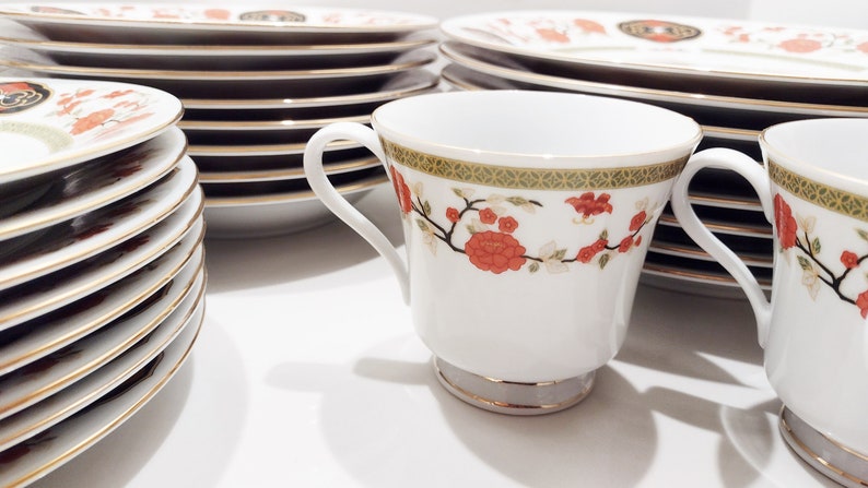 Lilily Cakara Dinnerware set, service for 8 Dinner plartes, salad plates, Soup Bowl, cup and saucer. Also Large oval platter, vegetable bowl and Covered Sugar (1)