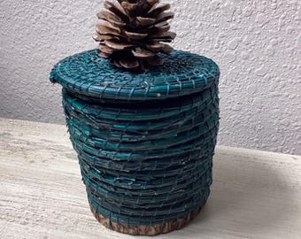 Teal pine needle basket with cover.