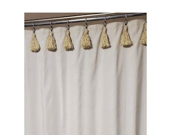 May include: A white shower curtain with a row of beige tassels along the top edge.