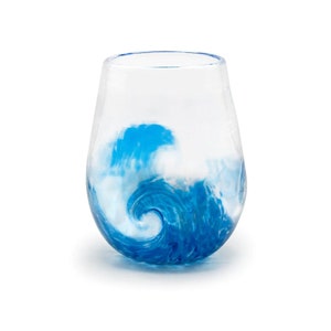 May include: A clear glass wine glass with a blue and white wave design.