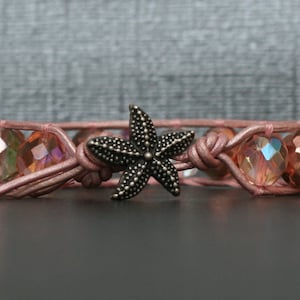 May include: A pink leather bracelet with iridescent pink glass beads and a silver starfish charm.